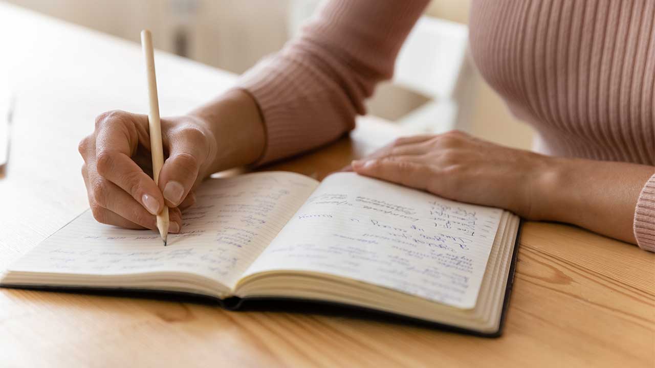 Hände eine Frau schreiben in ein Notiz- oder Tagebuch